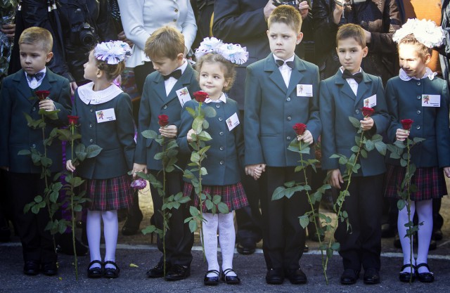 First-grade pupils attend a festive ceremony to mark the beginning of another academic year in Makiivka